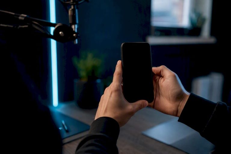 Hands recording YouTube Shorts on smartphone