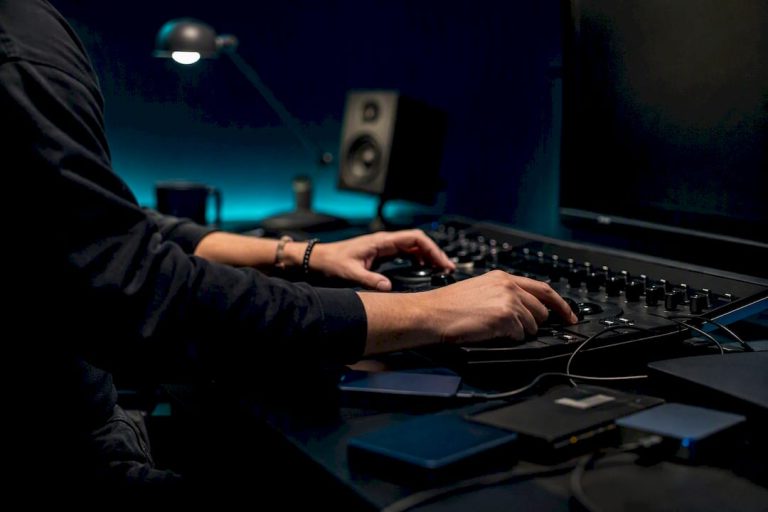 Hands adjusting video editing hardware controls